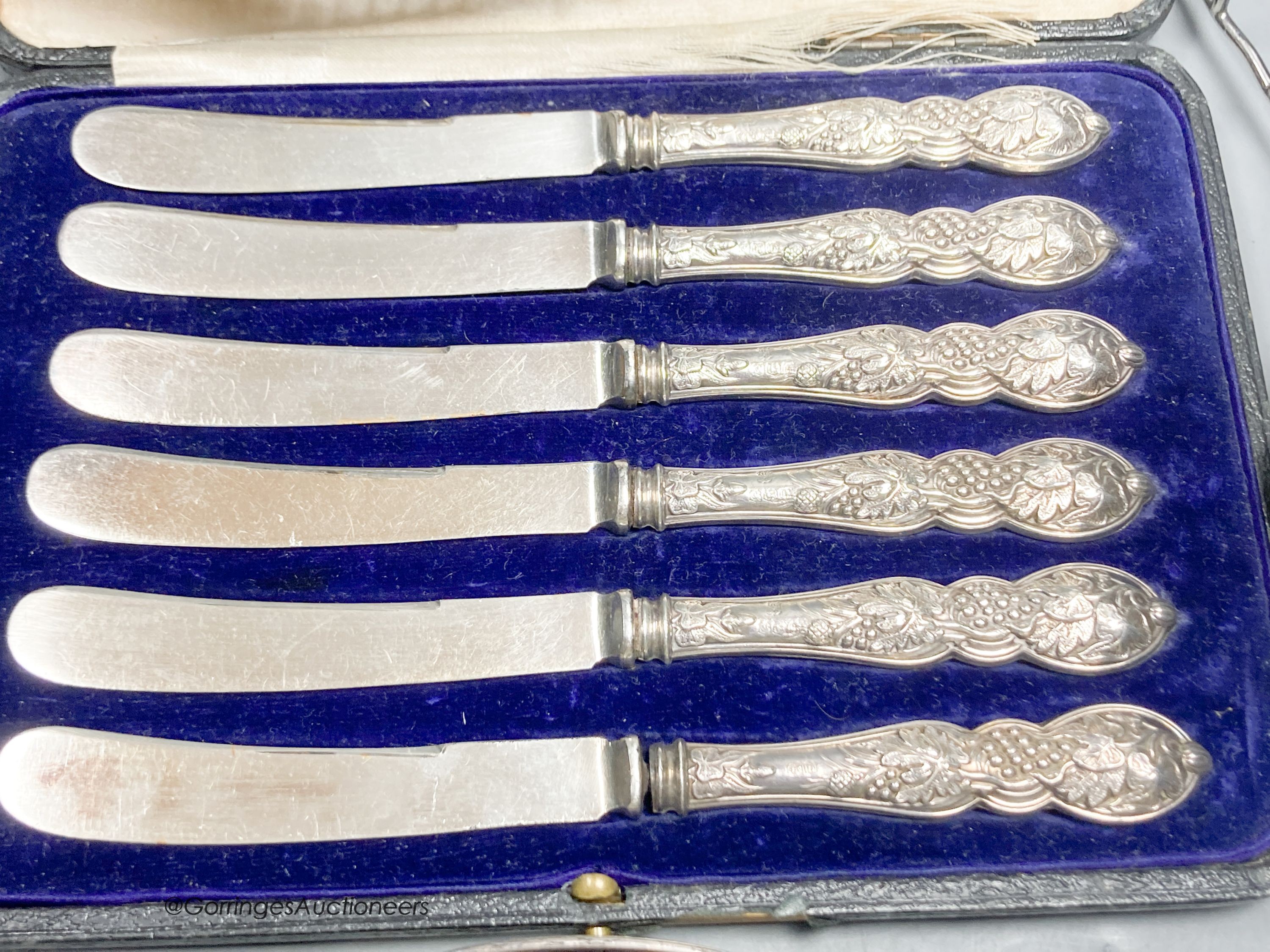 A George V silver two handled butter dish, with blue glass liner, a white metal basket, a pair of Victorian shell dishes, a French white metal dish, white metal toast rack and cased tea knives.